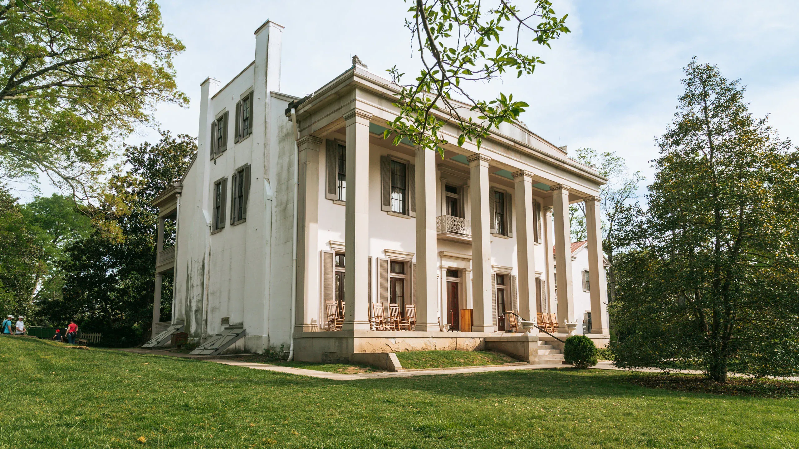 Historic Belle Meade estate surrounded by trees and lawn.