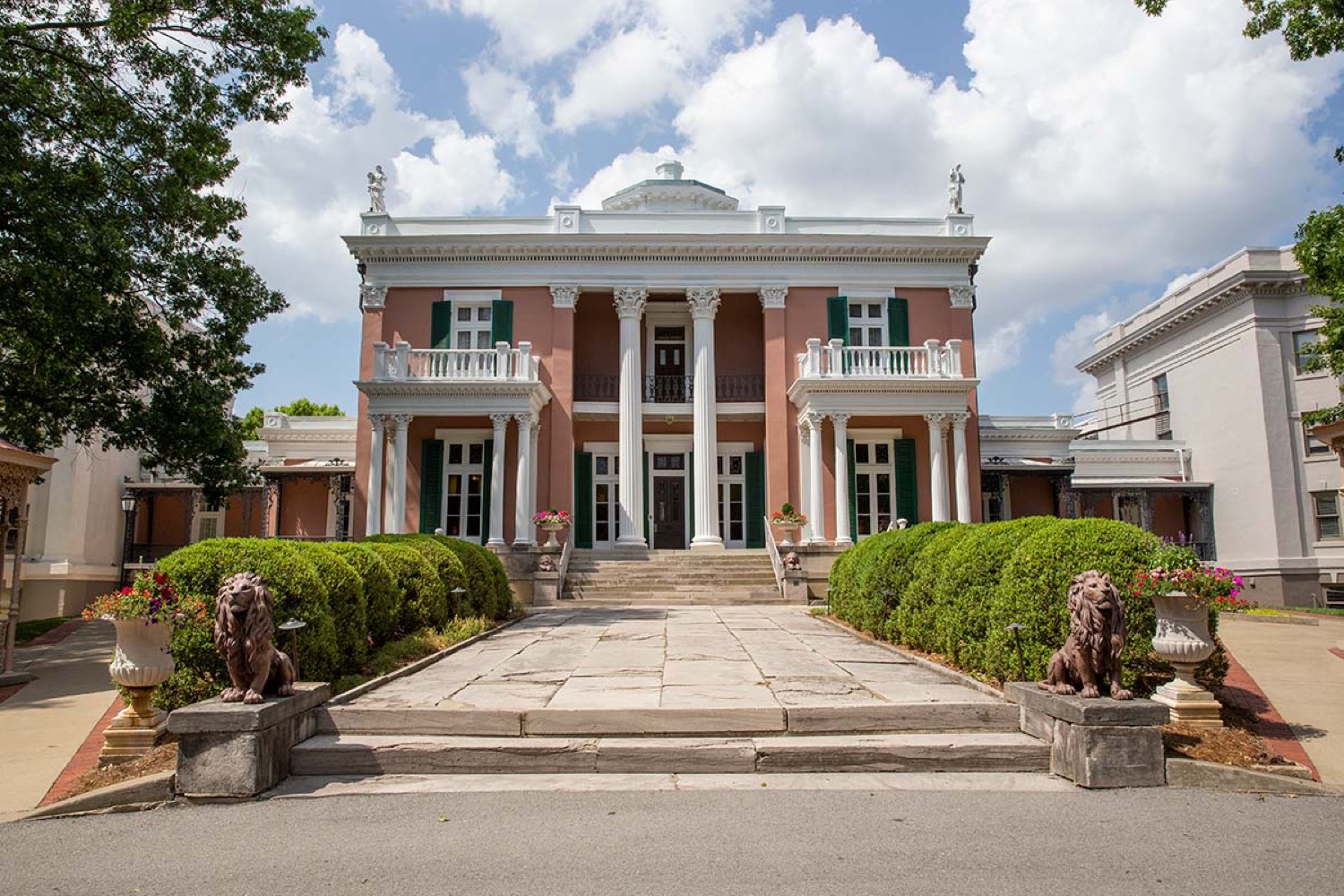 Belmont Mansion entrance framed by trees and blue sky in Nashville.