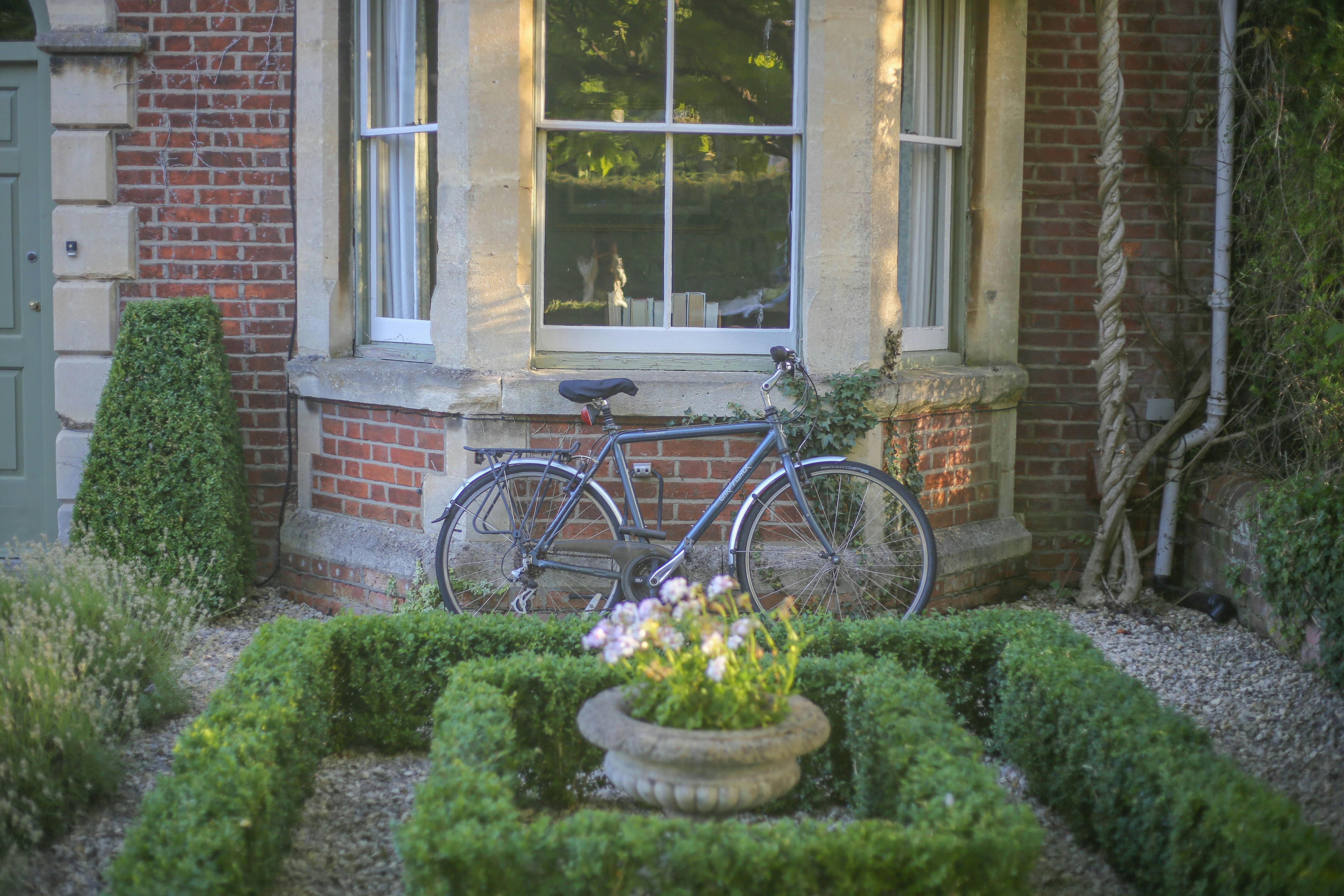Bike leaning against a home under a window in Sylvan Park.